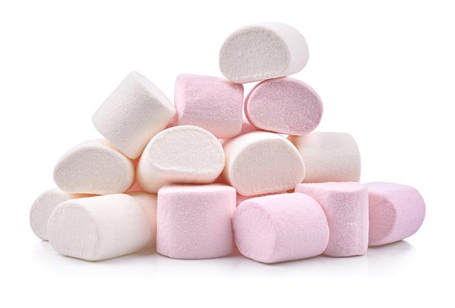 Pyramid shaped pile of pink and white marshmallows stacked on a white isolated background