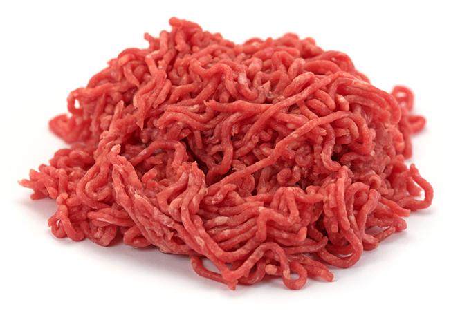 A pile of uncooked mincemeat on an isolated white background