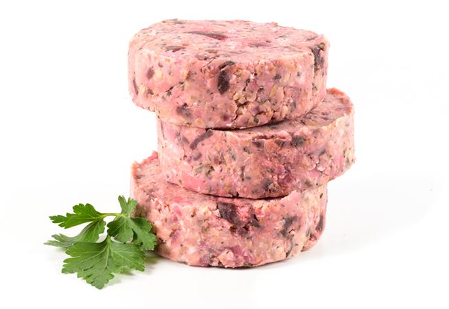 3 beetroot veggie burger pattie stacked on each other. Isolated on a white background